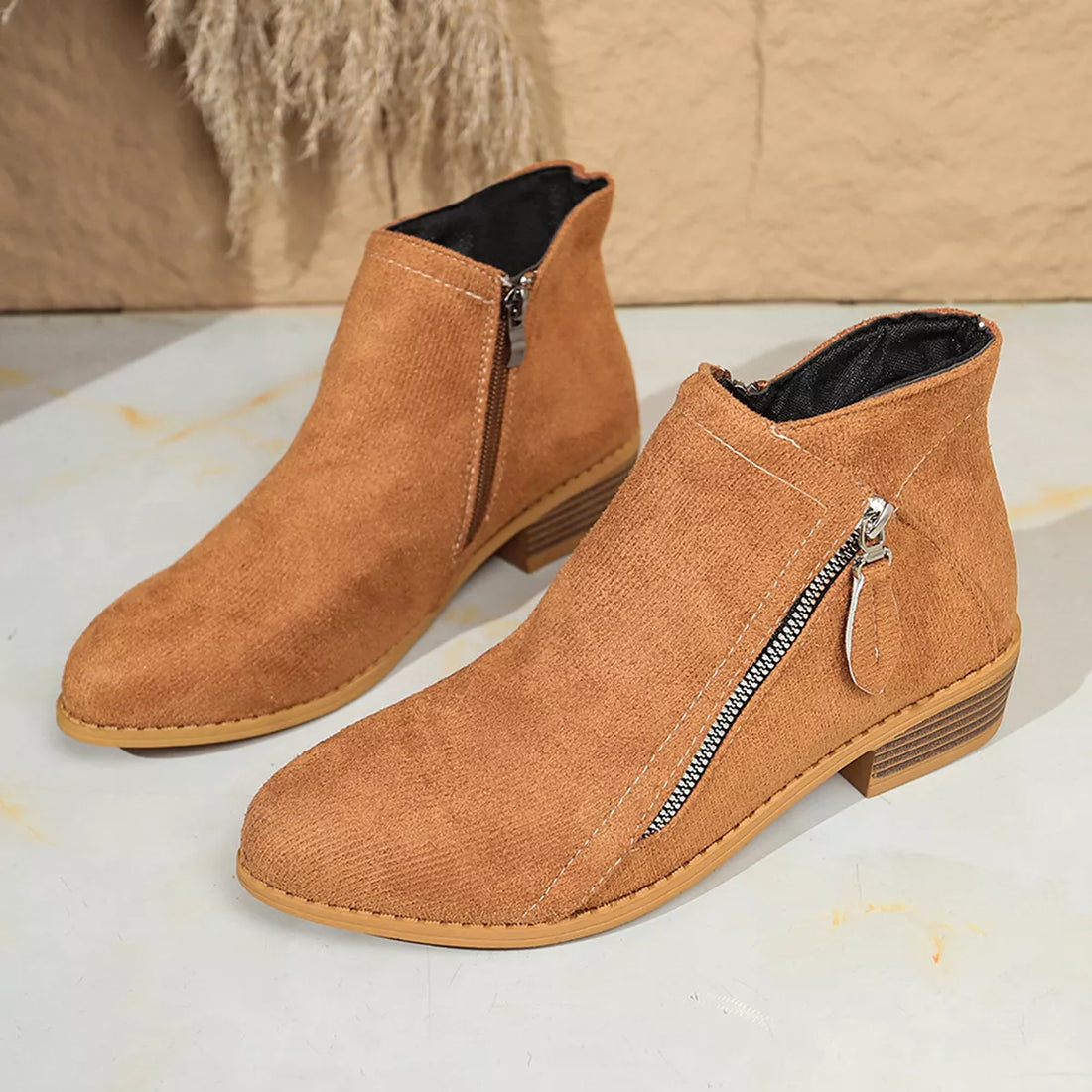 Brown suede ankle boots with pointed toe, side zip, and block heel