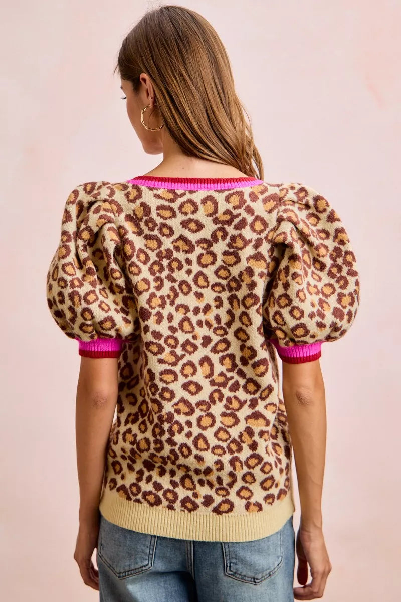 Leopard print sweater back view with puff sleeves and hot pink ribbed cuffs