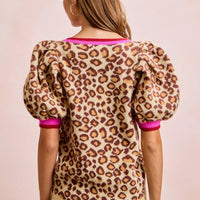 Leopard print sweater back view with puff sleeves and hot pink ribbed cuffs