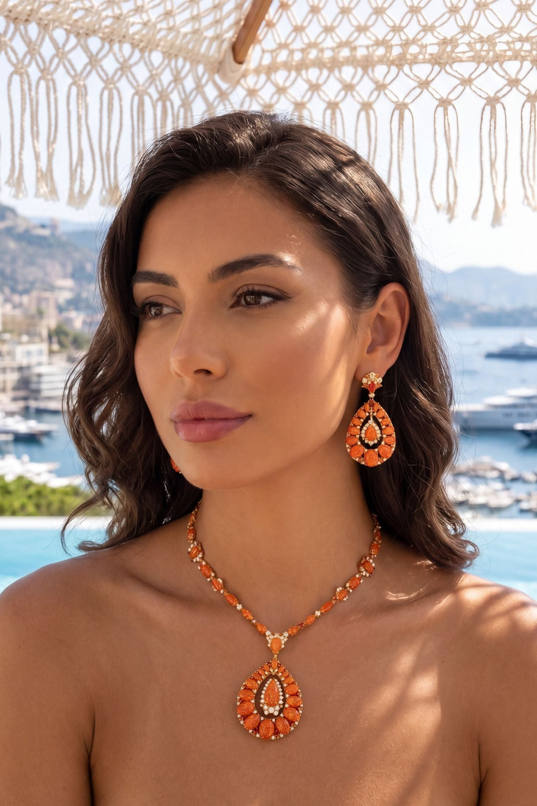 Orange gemstone statement necklace with gold-tone chain and teardrop pendant centerpiece