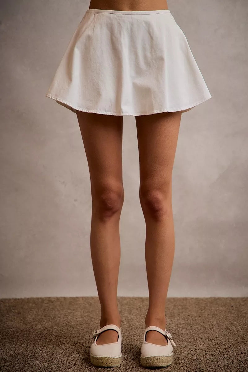 White denim bubble skort with flared hem and smocked back waistband