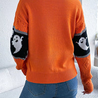 Orange sweater back view with black-and-white ghost stripe on the sleeves