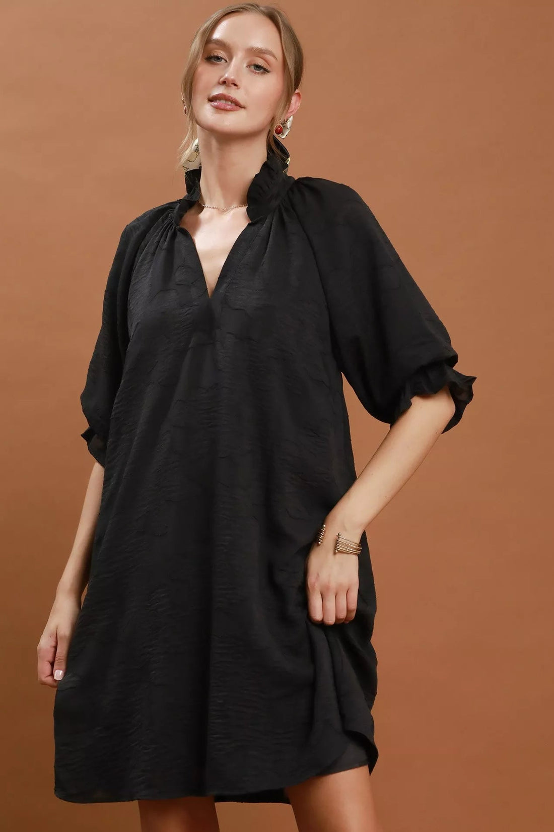 Black V-neck textured dress with gathered shoulders and short puff sleeves