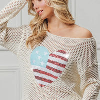 Off-white sequin knit sweater with American flag heart design, wide neckline.