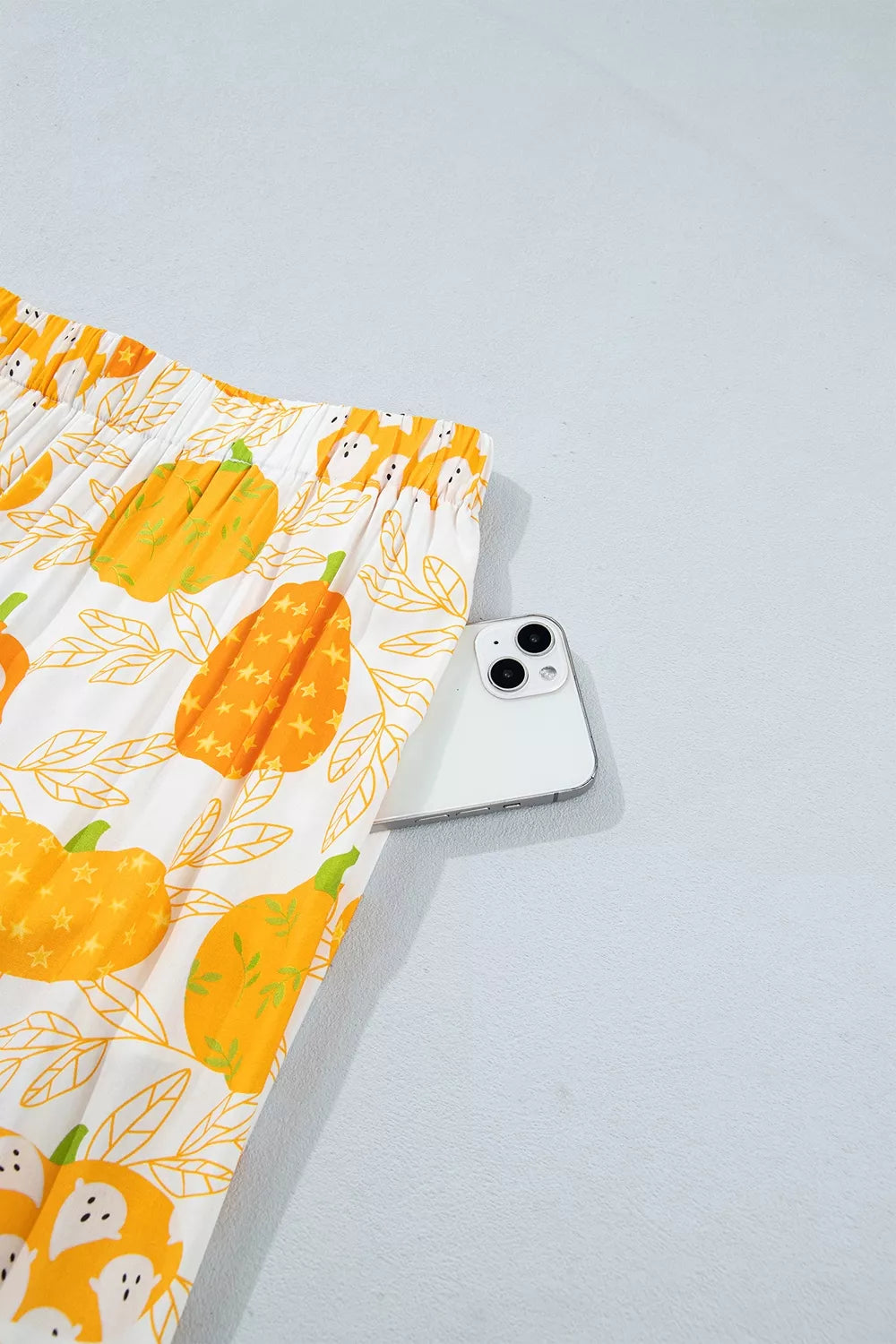 Printed lounge shorts with pumpkin and animal motif; shown near waistband
