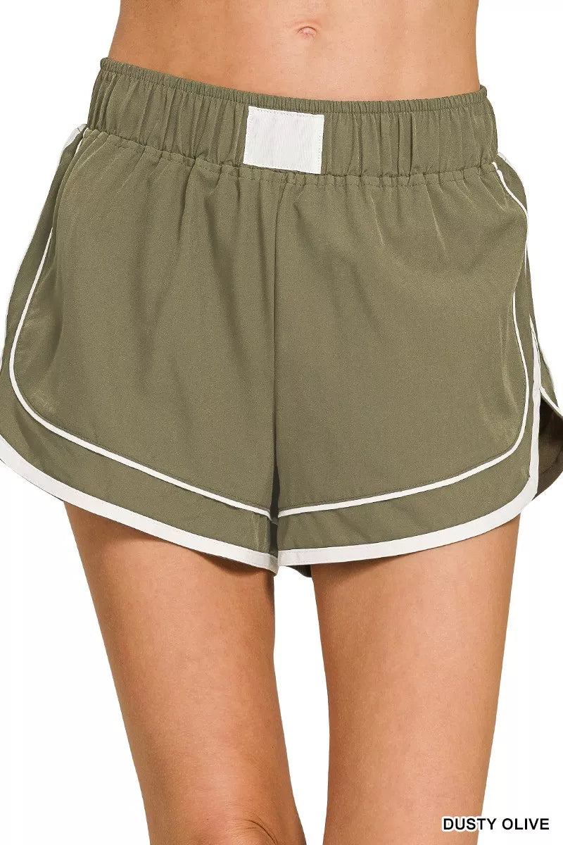 Dusty olive dolphin shorts, soft woven lined, elastic waist with white trim