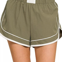 Dusty olive dolphin shorts, soft woven lined, elastic waist with white trim