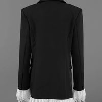 Back view of black blazer with lace-trim hem on a mannequin