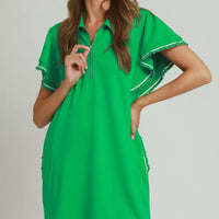 Green mini dress with half-zip collar, ruffled sleeve trim, and side pockets