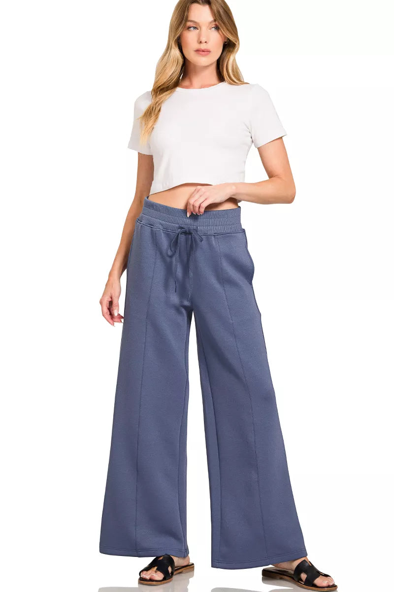 Blue indigo wide-leg center-seam pants with an off-white short-sleeve cropped top