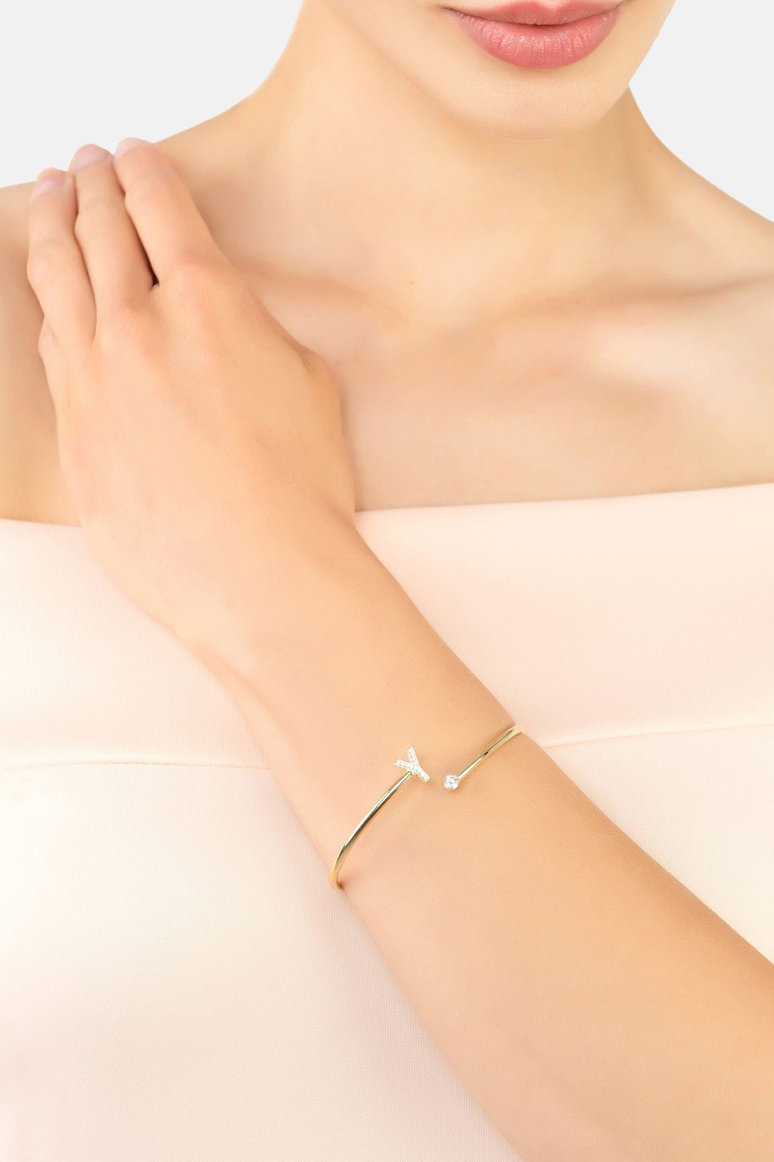 Silver-tone Y initial bangle bracelet worn on wrist with small crystal accents
