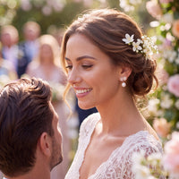 Rose gold pearl drop earrings on a bride with floral stud details