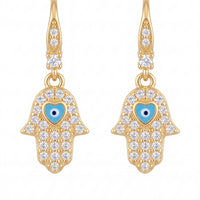 Gold hamsa hand drop earrings with blue eye and clear stone halo