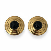 Gold round stud earrings with layered spiral design and black onyx center.