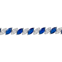 Close-up sapphire tennis bracelet row with oval blue stones on silver links