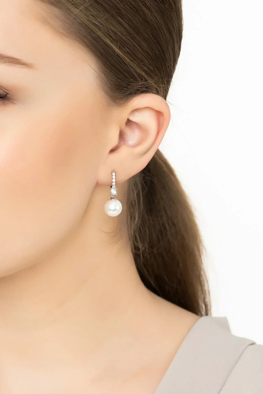 Silver hoop earrings with a pearl drop