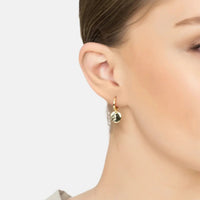 Gold huggie hoop earrings with round moon charm, worn on ear