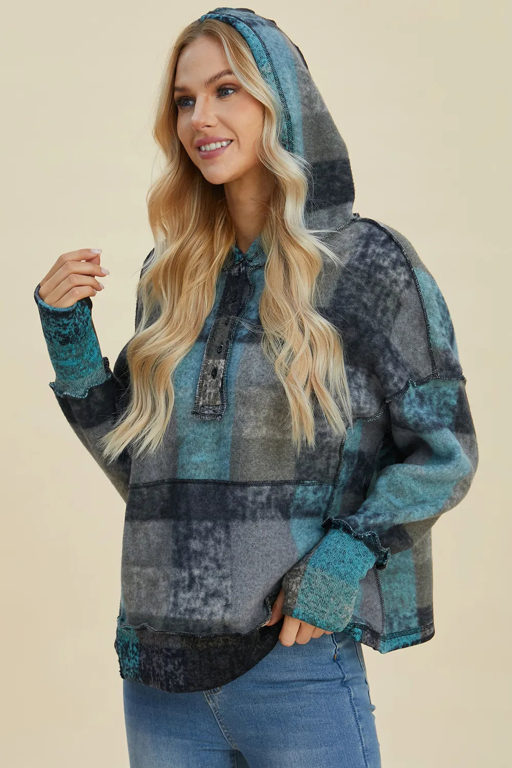 Plaid fleece hoodie with hood, half-zip, dropped shoulders, side view with hand pocket.