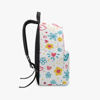 Side view small canvas kids backpack with colorful doodle rainbow print and hanging cord