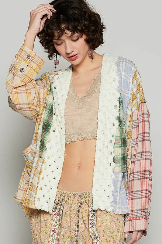 Open-front plaid cardigan with raw-edge white trim, multicolor cuffed sleeves