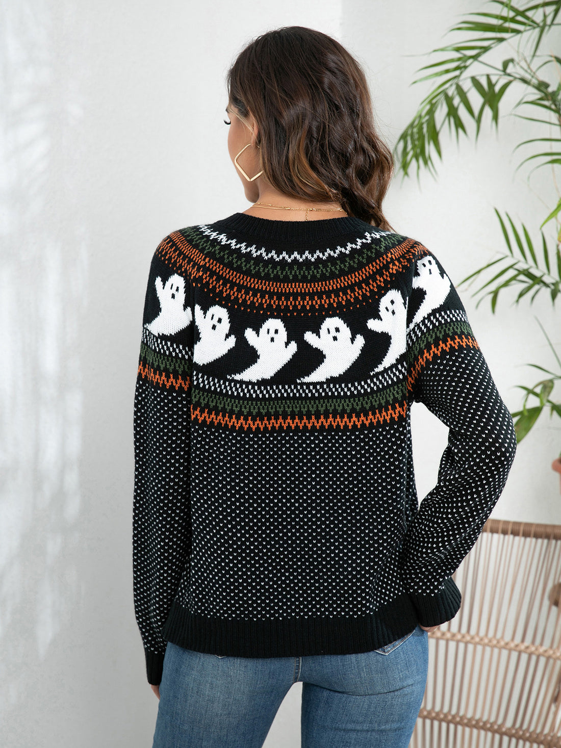 Black ghost-pattern button-up cardigan sweater showing full back and long sleeves