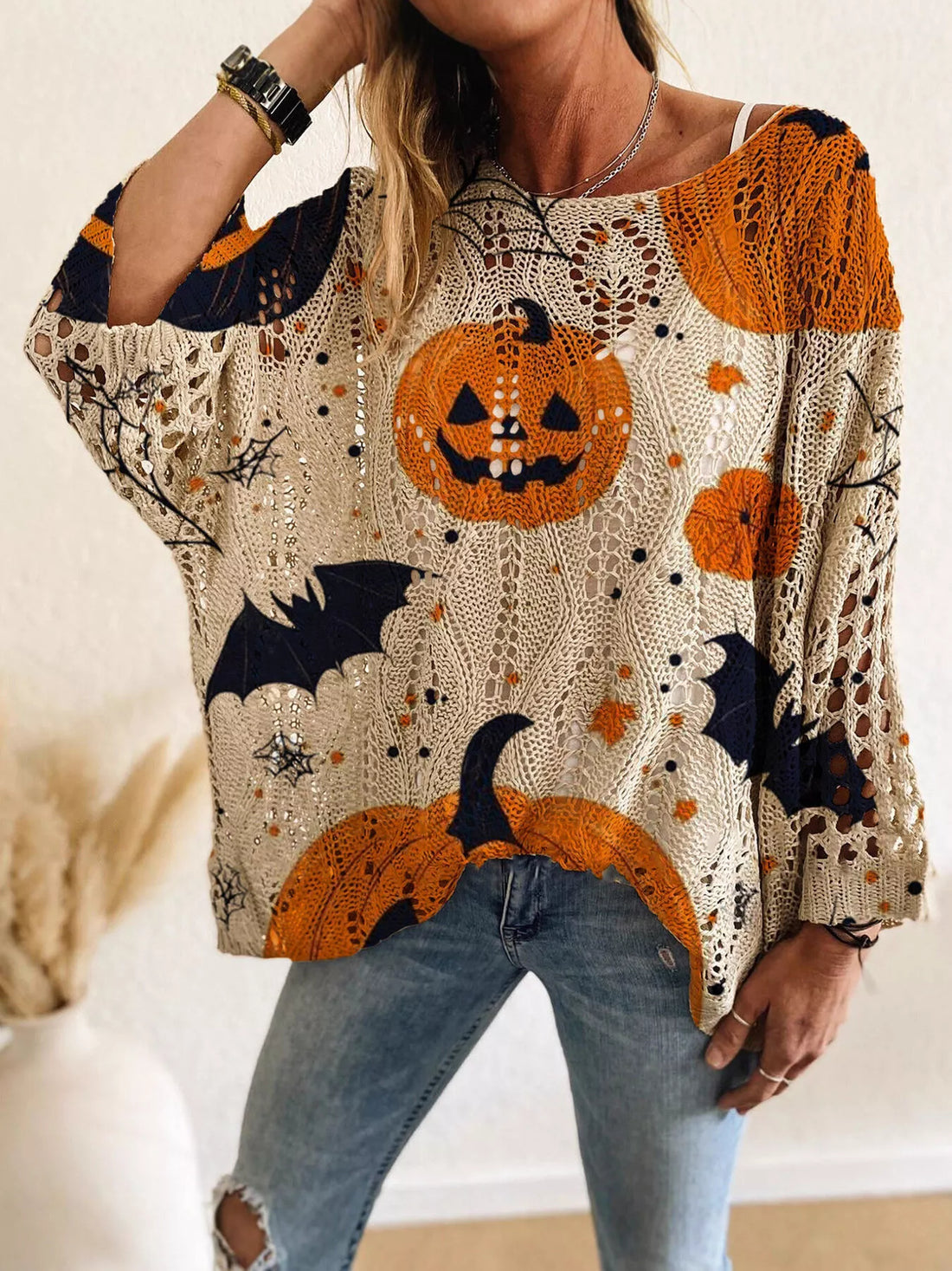 Plus size loose knit cover-up with pumpkin, cat and moon graphic print in orange and dark navy.