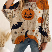 Plus size loose knit cover-up with pumpkin, cat and moon graphic print in orange and dark navy.