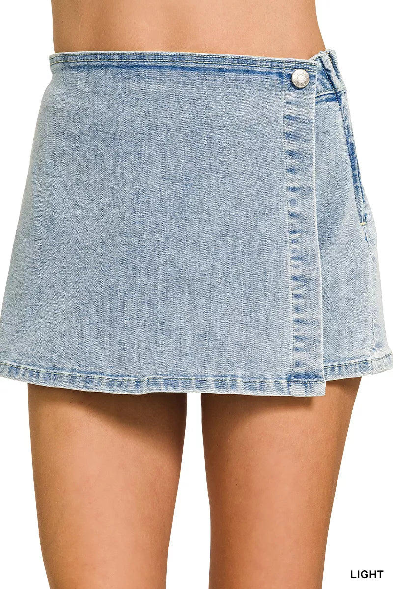 Light wash denim wrap-front skort with button closure and stitched hem