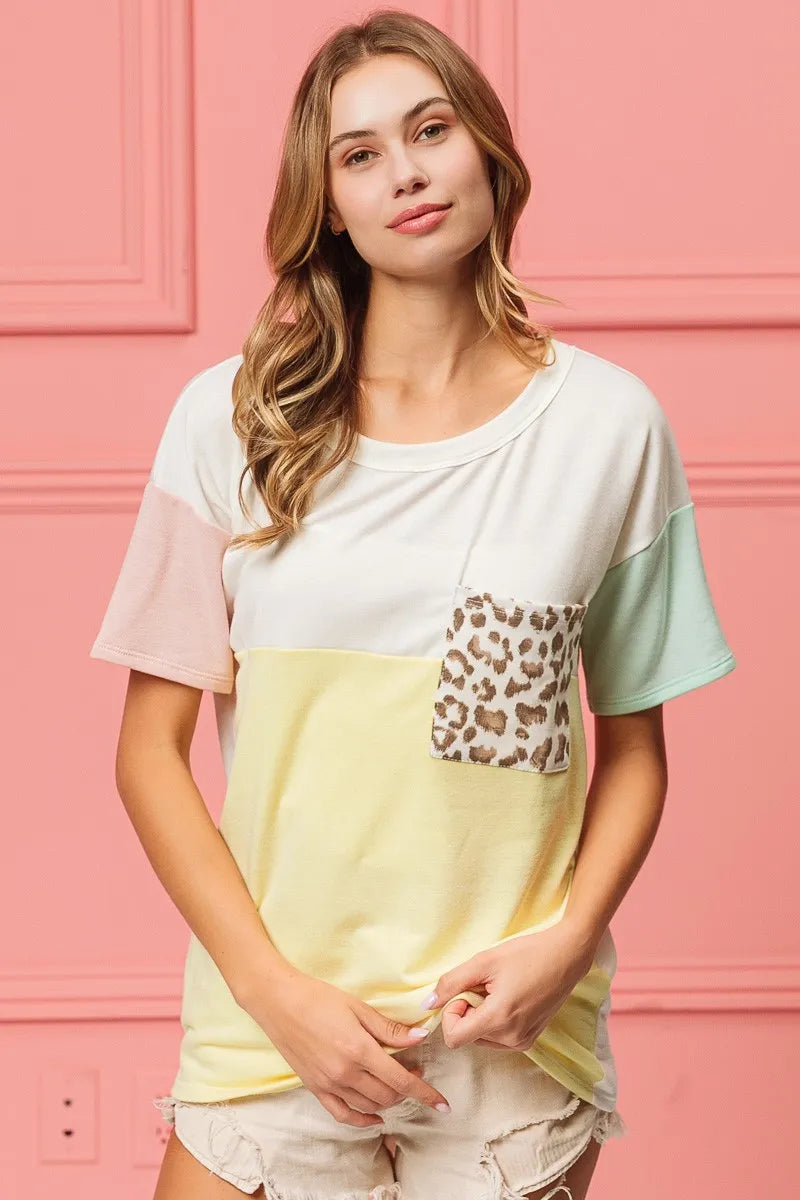 Color block crew neck top with leopard print front pocket, short sleeves, pale yellow base