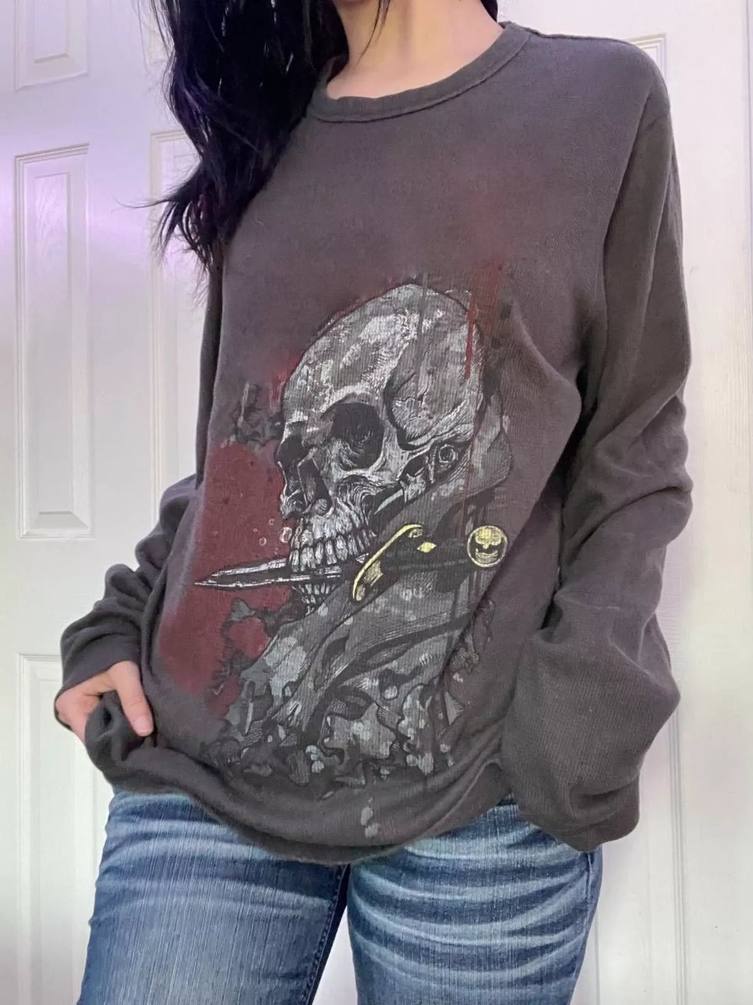 Dark gray long sleeve t-shirt with skull and skeleton graphic on front