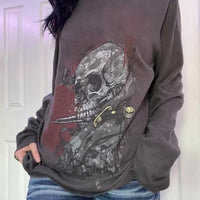 Dark gray long sleeve t-shirt with skull and skeleton graphic on front