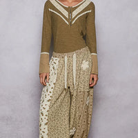 Olive ribbed knit top with white V trim, contrast cuffs, and half-button front