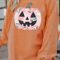 Orange sherbet tunic sweatshirt with patchwork pumpkin graphic and long cuffed sleeves