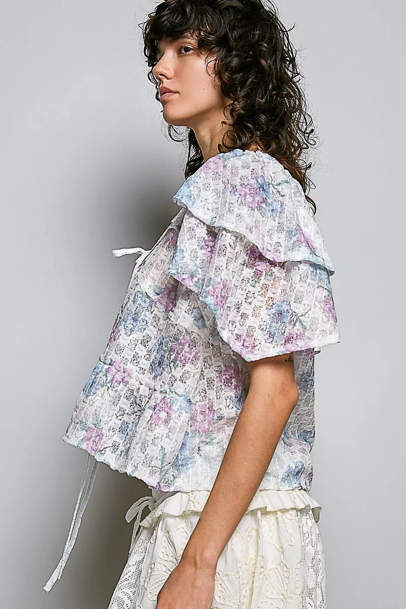 Side view floral tie-front ruffle blouse with lace trim, off-white pastel print