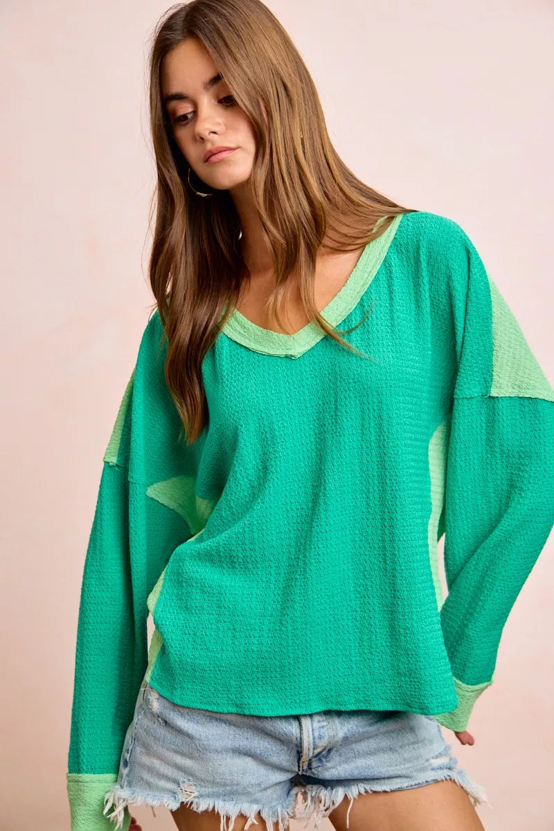 Textured jersey color block top in emerald green with light green side contrast panels