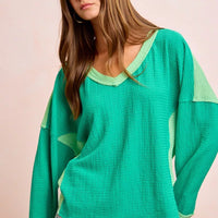 Textured jersey color block top in emerald green with light green side contrast panels