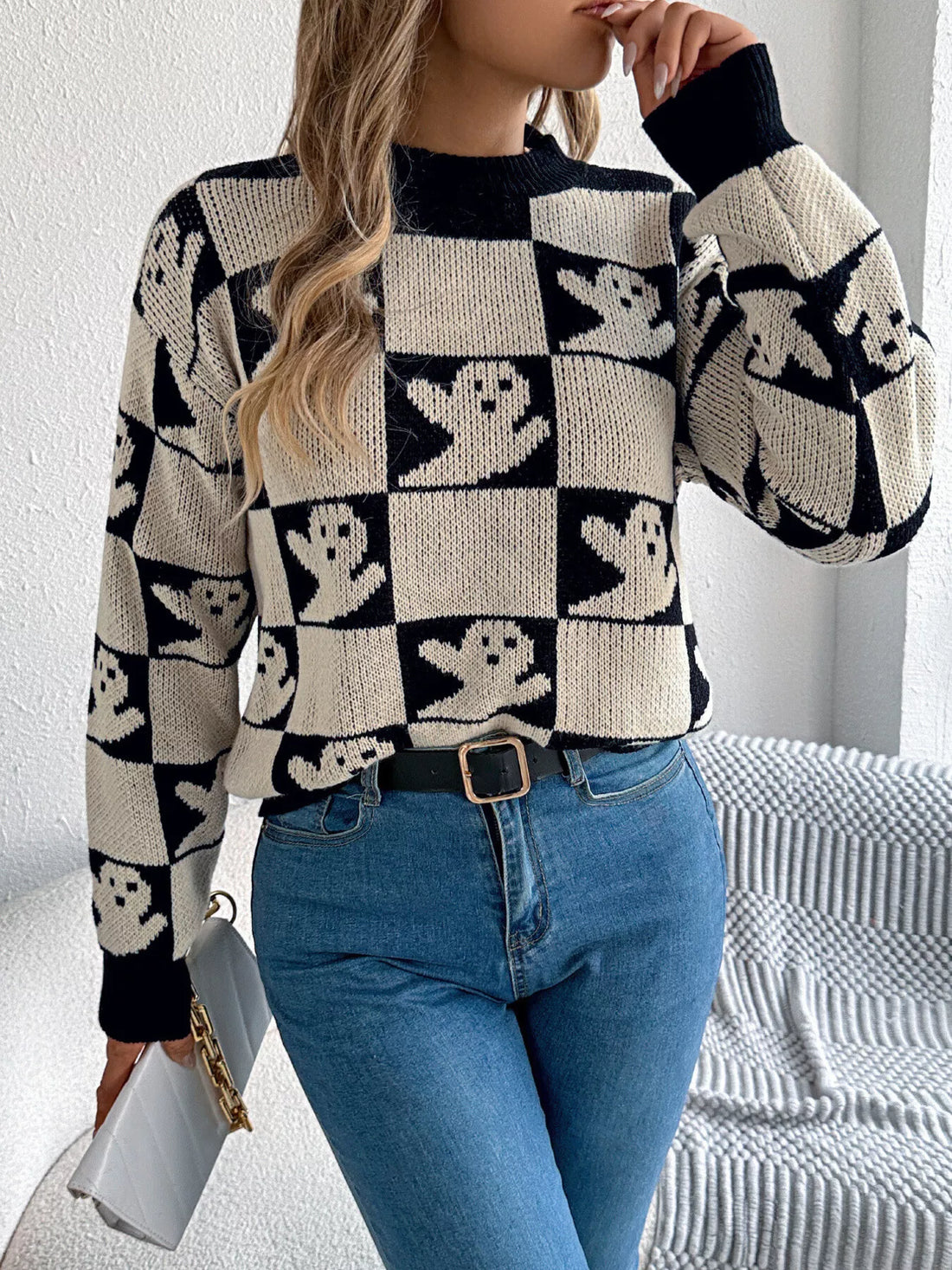 Black and ivory checkerboard graphic sweater with ghost faces, crew neck, long sleeves