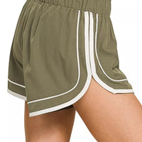Dusty olive lined dolphin shorts with elastic waist and white contrast side panels