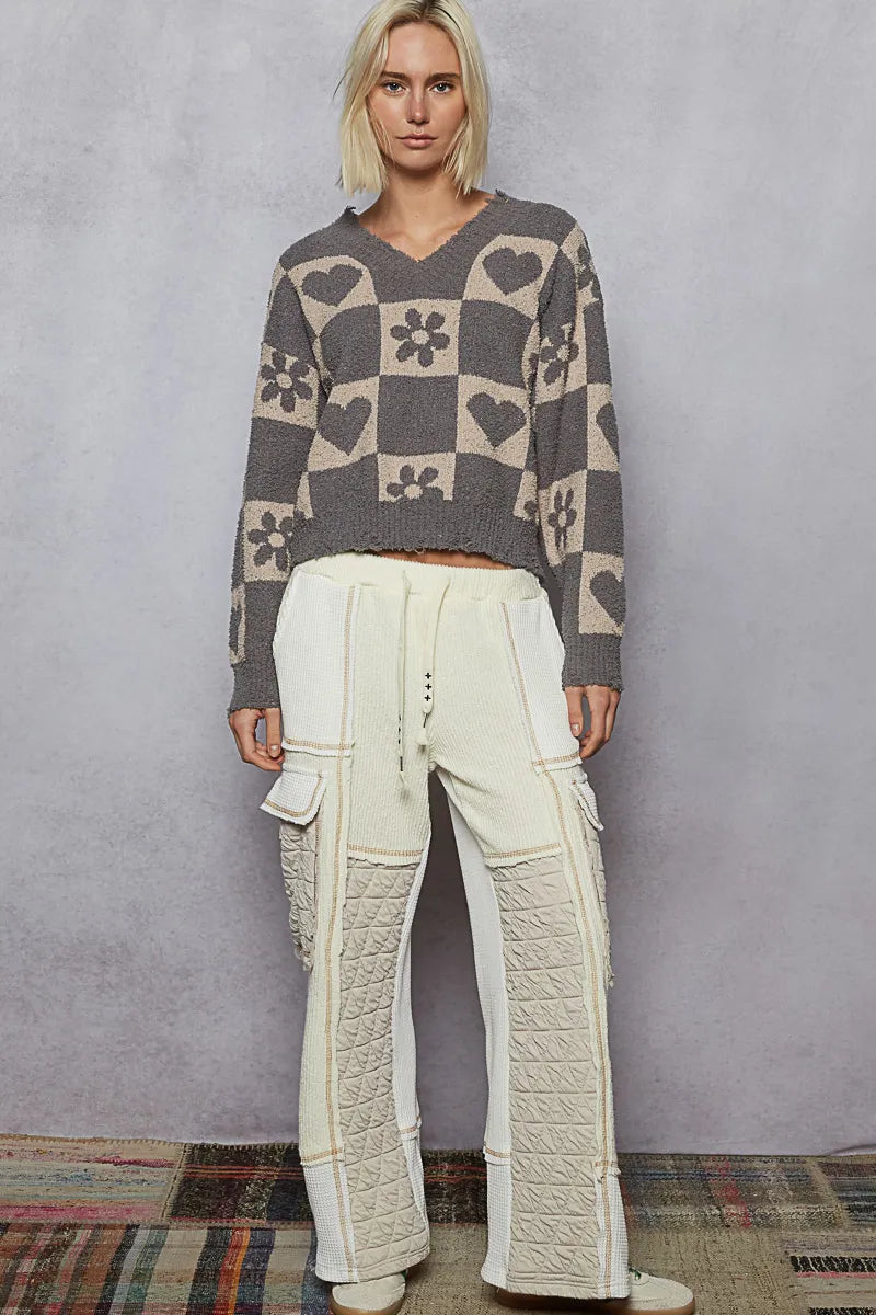 Women’s heart checkered V-neck sweater, gray with beige hearts and flowers, long sleeves.