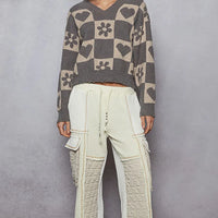 Women’s heart checkered V-neck sweater, gray with beige hearts and flowers, long sleeves.