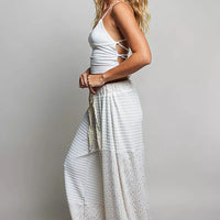Ivory patchwork knit wide-leg pants with elastic waist and textured vertical seam detail
