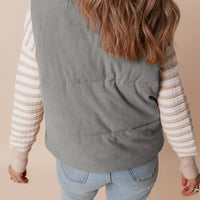 Gray corduroy stand-neck zipped puffer vest, back view with quilted channel stitching.