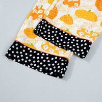Printed lounge shorts with black polka-dot panels and pumpkin print trim