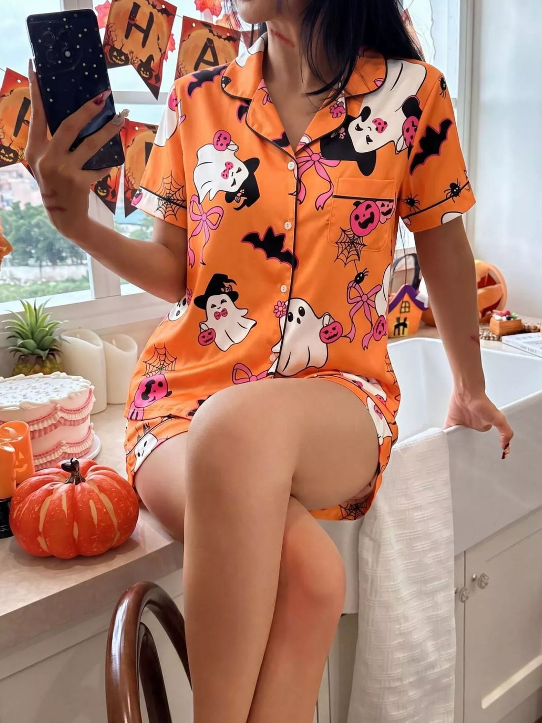 Orange Halloween lounge set with button-down short-sleeve shirt and printed matching shorts