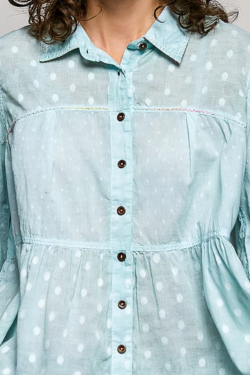 Aqua polka-dot woven shirt close-up: button placket and gathered waist panel