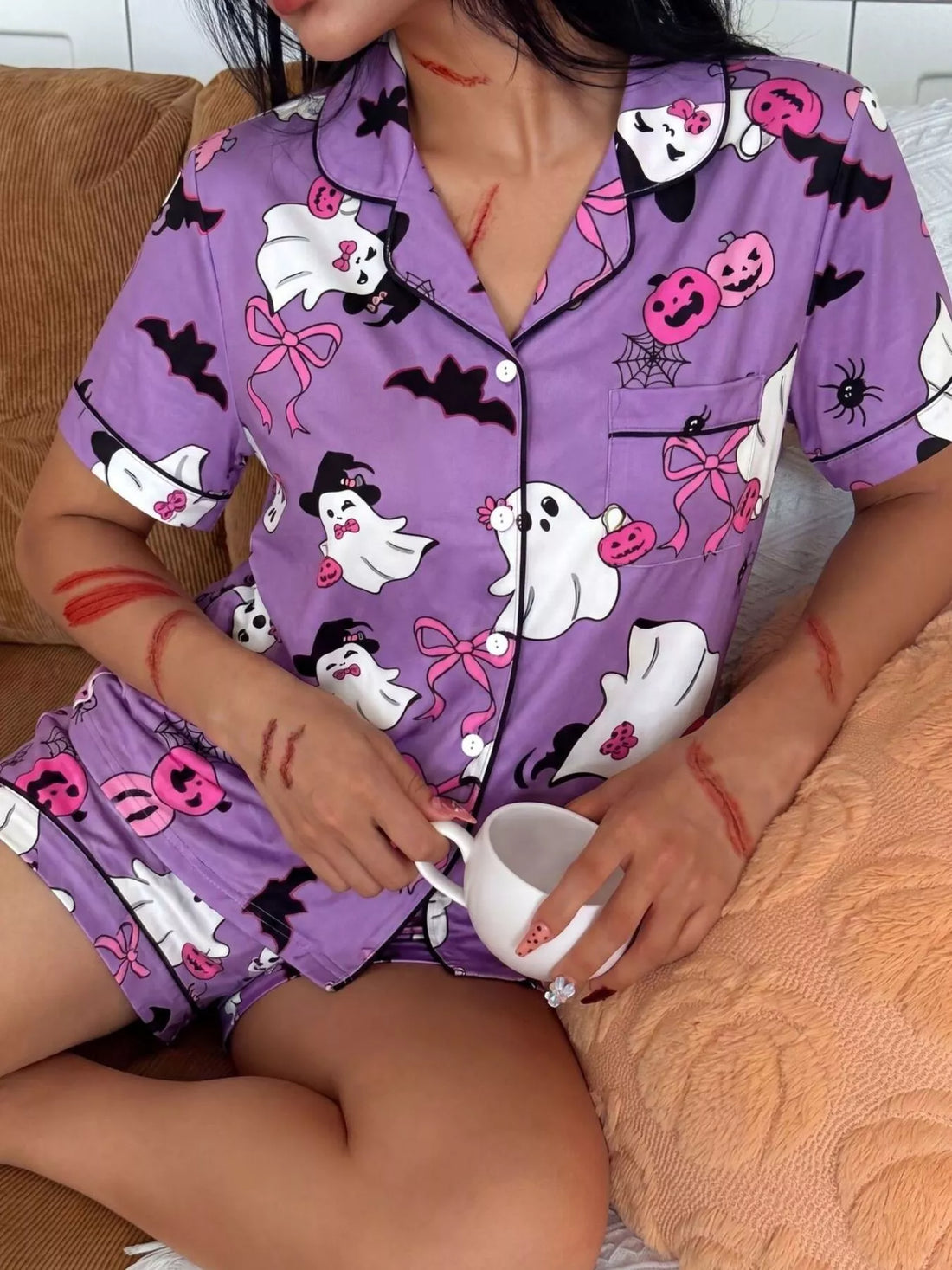 Purple pajama set: button-front short-sleeve top with ghost, bat, and pumpkin prints