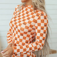 Halloween long sleeve mock neck blouse, side view, orange-and-white check with jack-o’-lantern faces
