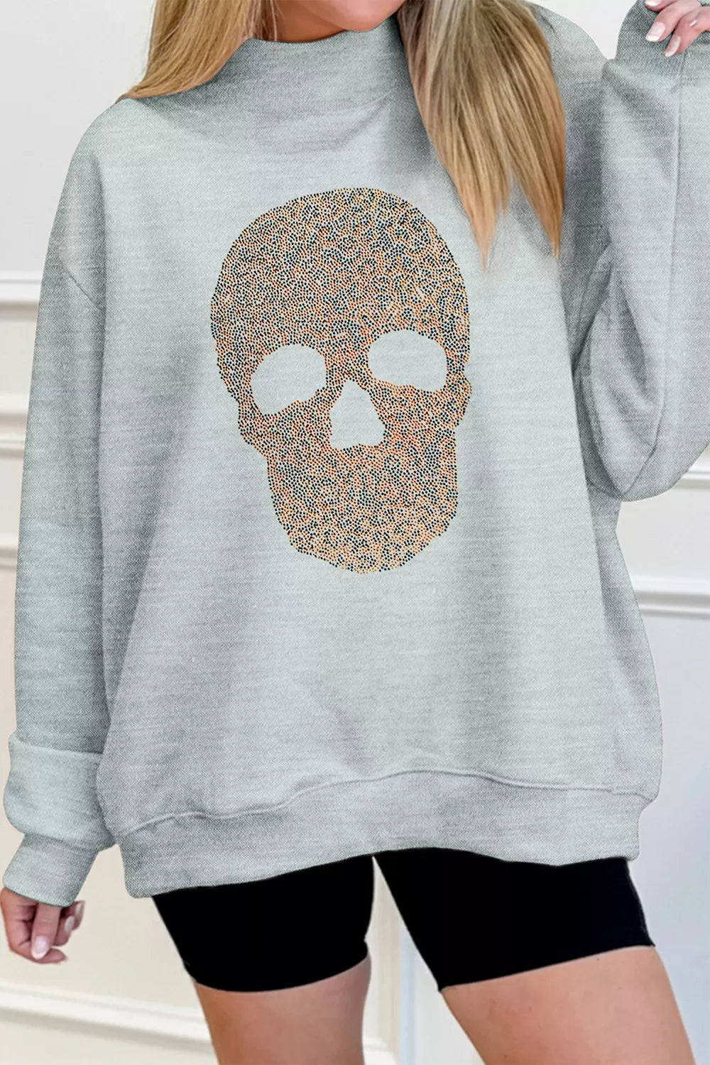 Gray mock-neck pullover sweatshirt with glitter skull graphic, front view