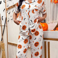 Halloween pajama set: white button-up top and pants with orange jack-o'-lantern and ghost prints