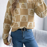 Ghost-pattern checkered round-neck sweater in tan and cream, long sleeves.